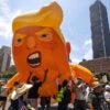 Thousands of protesters rally in Los Angeles on Saturday at a demonstration against President Donald Trump, including with a gigantic balloon caricaturing him.