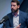Babylon Bee CEO Seth Dillon speaking into microphone